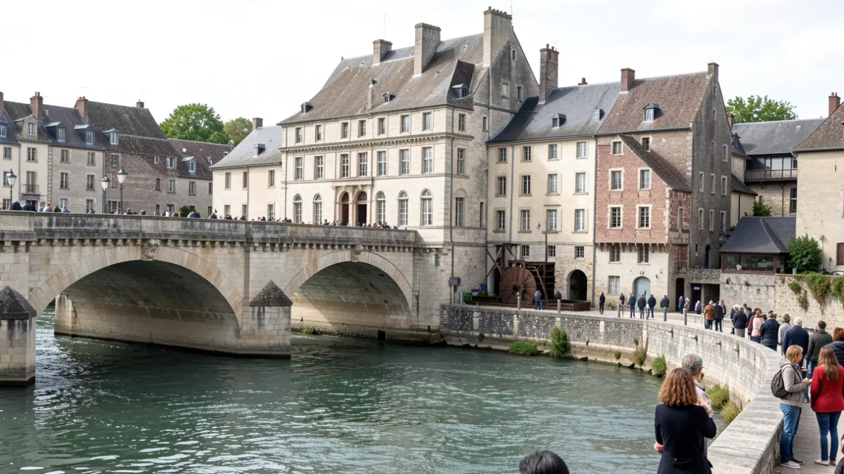 The Pont de Noblat in Saint-Léonard, showcasing centuries of history with its mills and church.
