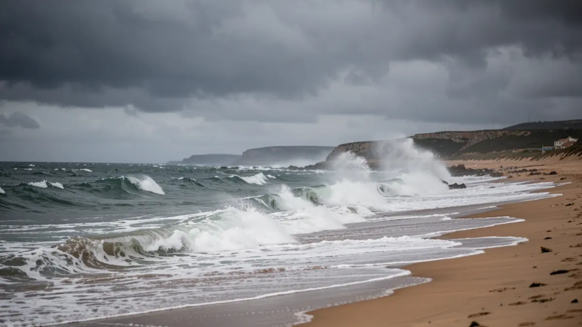 Generic image of crashing waves on a beach during a storm, with a threatening grey sky.